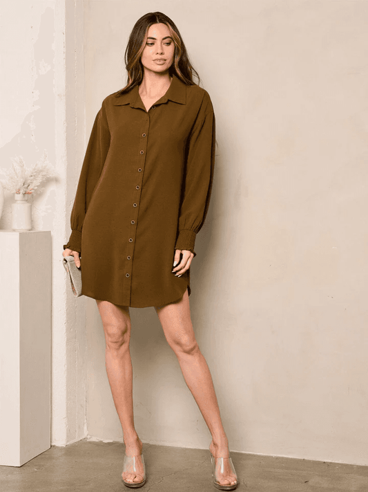 Woman wearing brown long sleeve casual dresses for women with button front and collar standing indoors