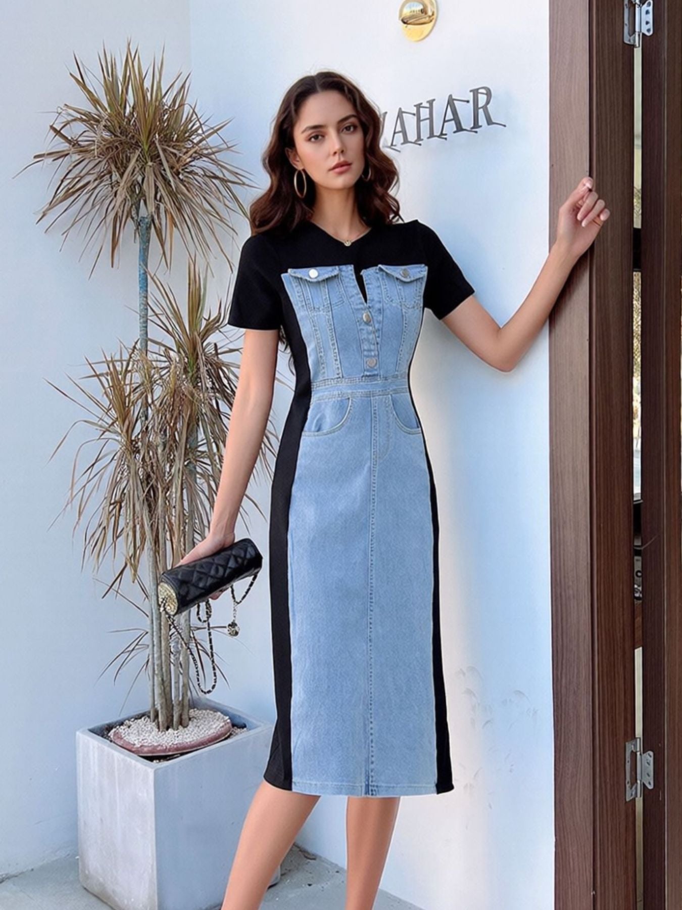 Woman wearing a stylish black and denim midi dress from Erina's Boutique plus size dress clothes collection