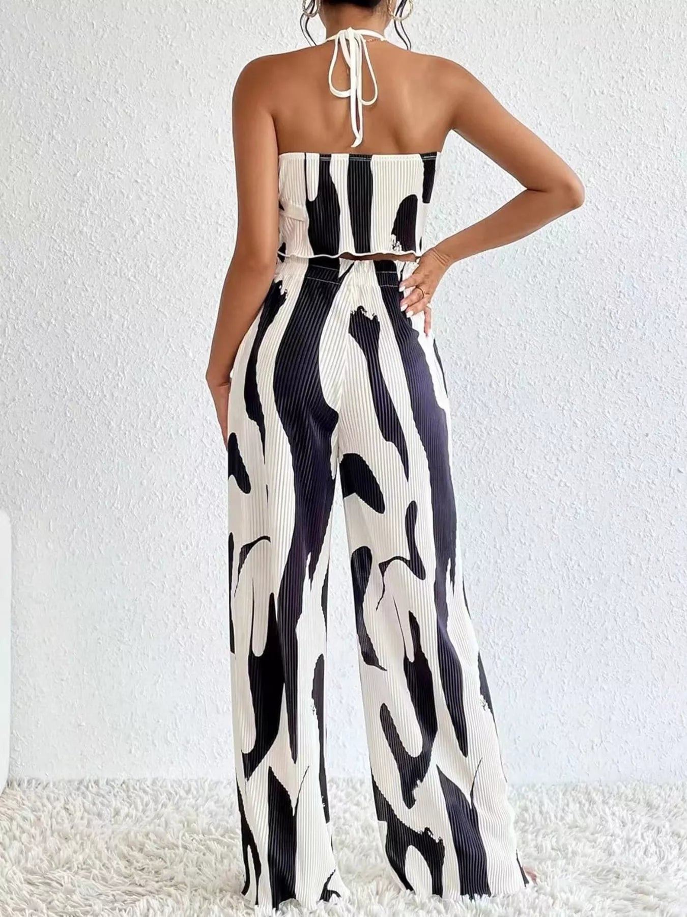 Black and white patterned wide leg trouser pants for women styled with a matching strapless top