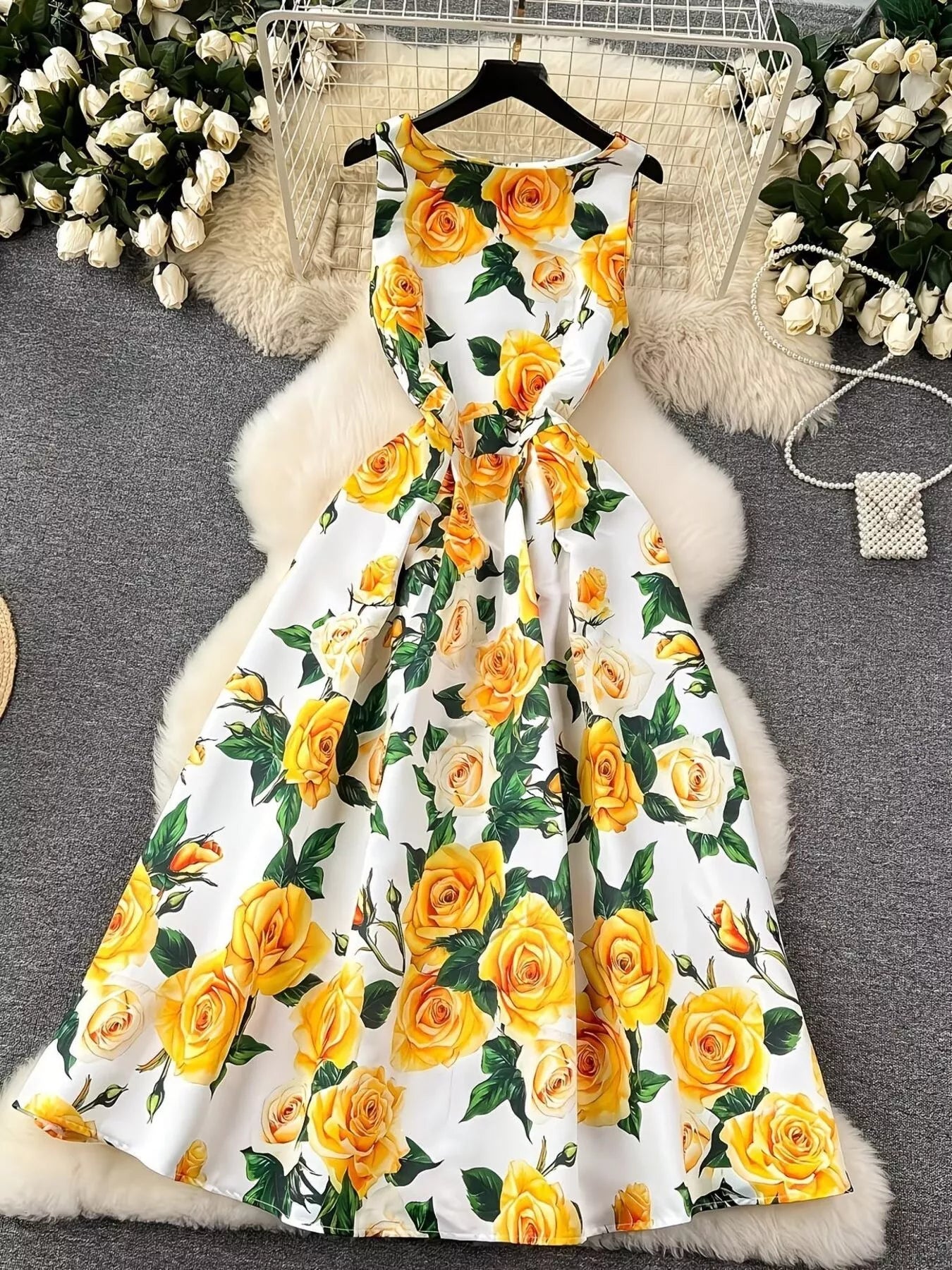 White floral dress dress with bright yellow rose print and green leaves from Erina's Boutique