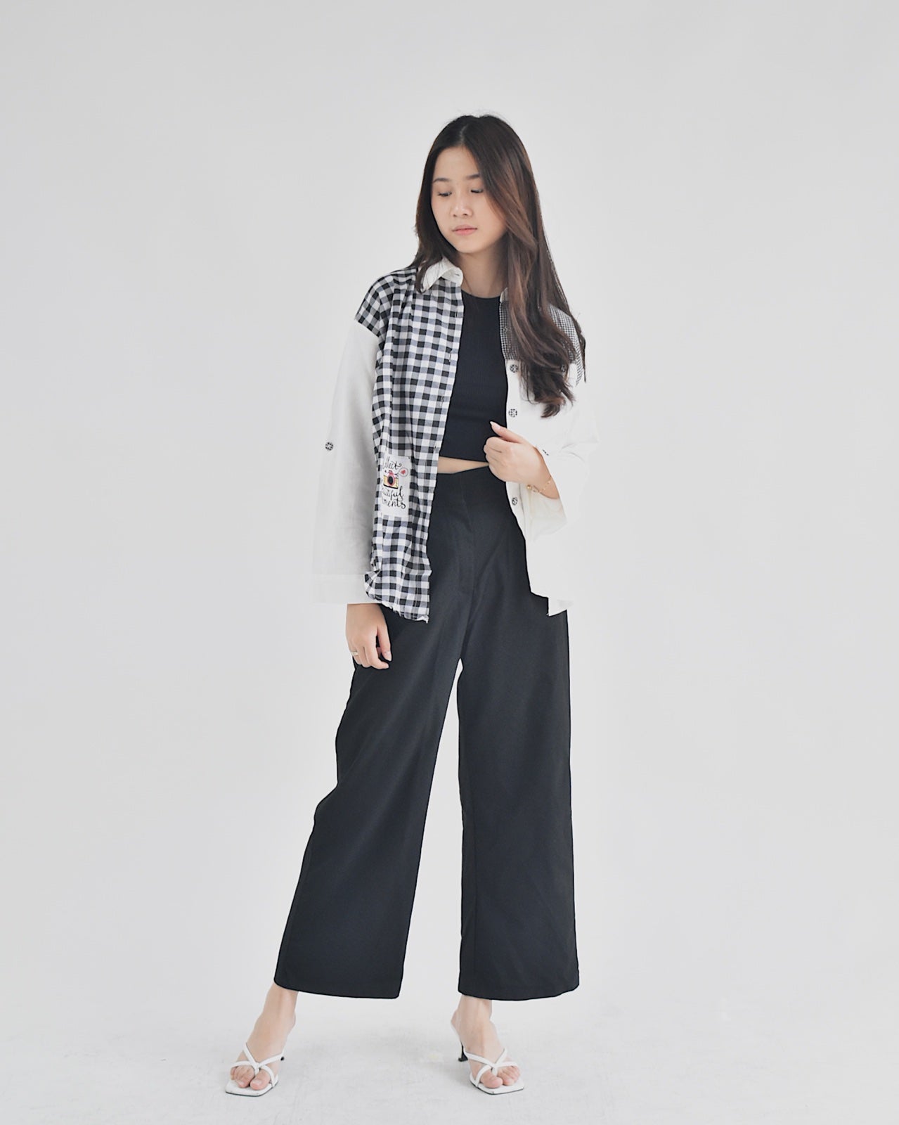 Affordable women's fashion shirt with black and white checkered pattern styled with black pants and white jacket