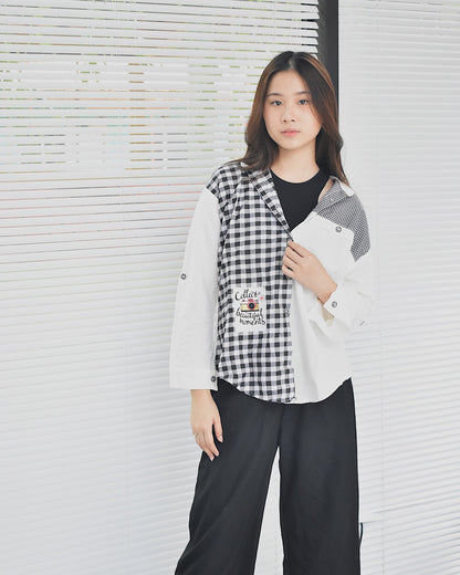 Young woman wearing an affordable women's fashion shirt with black and white checkered and solid patterns