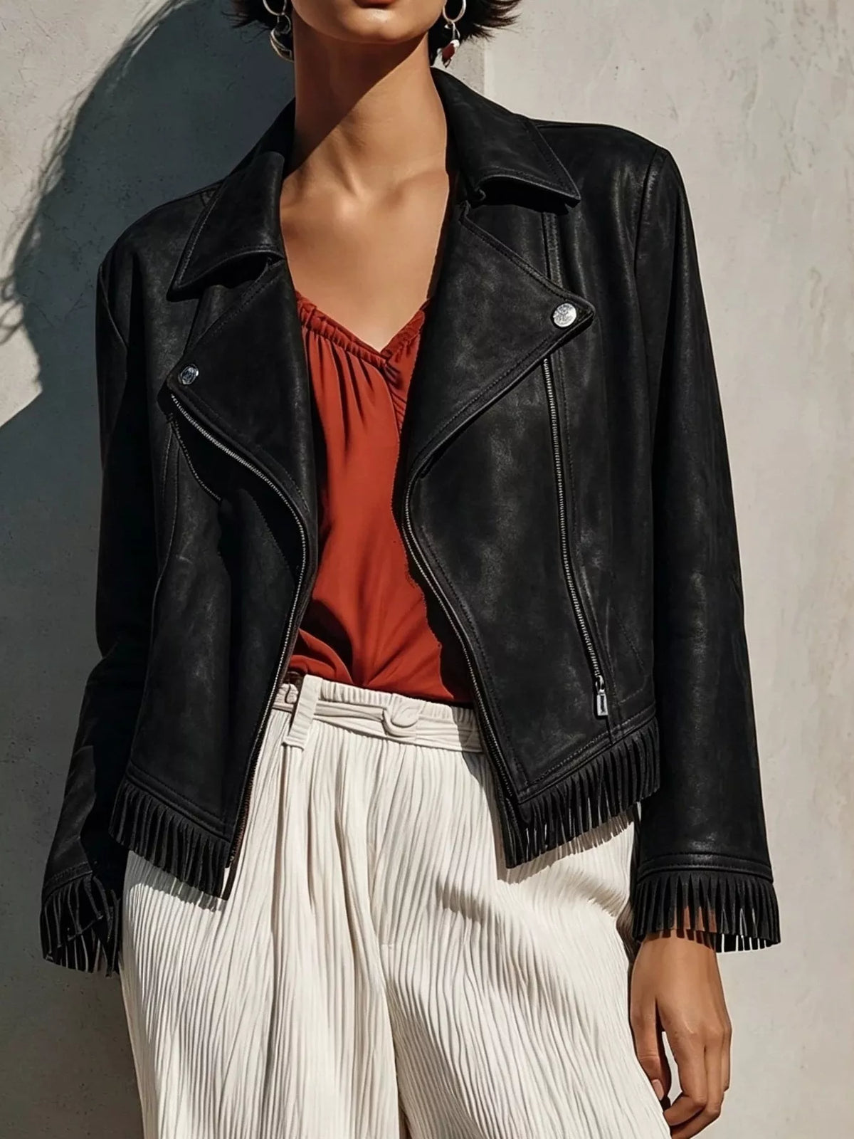 Black leather zip up jacket with fringe details on cuffs and hem from Erina's Boutique
