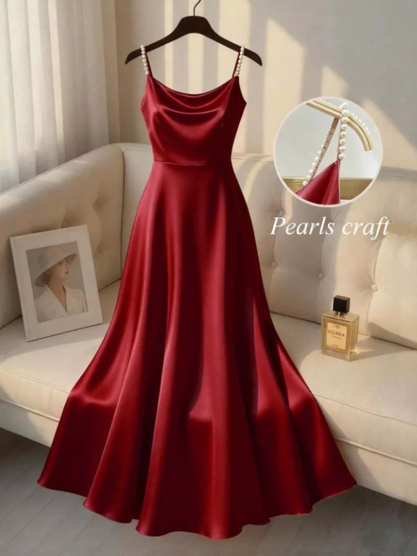 Elegant red satin cloth dress with pearl-crafted straps displayed on a hanger at Erina's Boutique