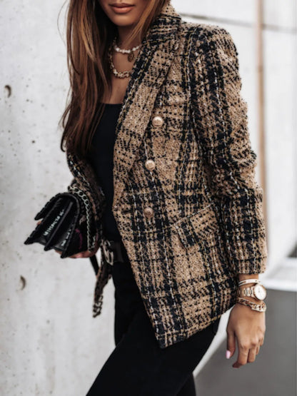 Stylish women's tweed blazer in beige and black plaid worn with black top and accessories