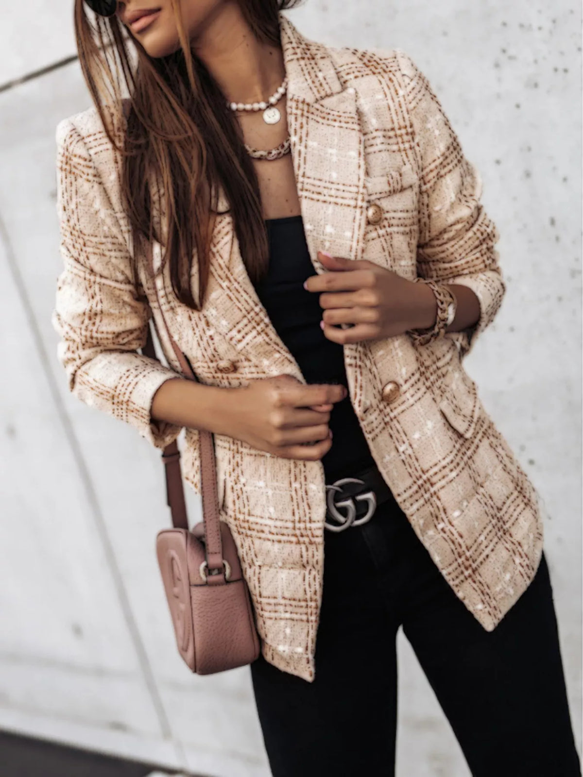 Woman wearing a stylish women's tweed blazer in beige plaid pattern with double buttons and long sleeves